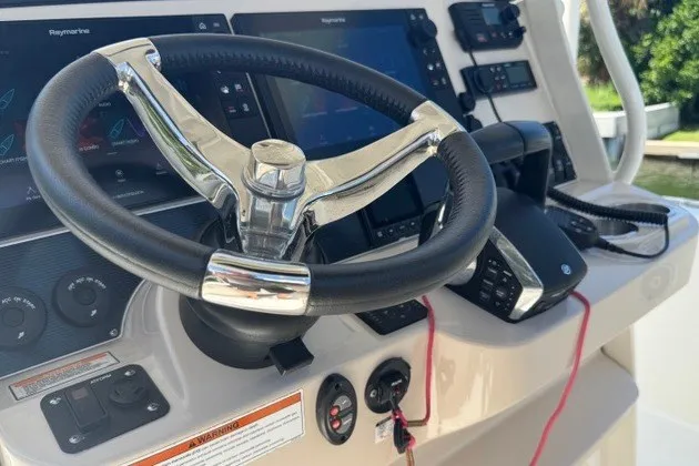 Slide: The Image of Steering wheel and controls of 2022 Boston Whaler 270 Dauntless boat. - 31