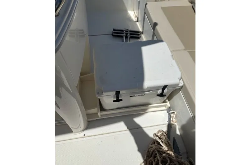 Slide: The Image of 2022 Boston Whaler 270 Dauntless boat interior with storage compartment and rope. - 26