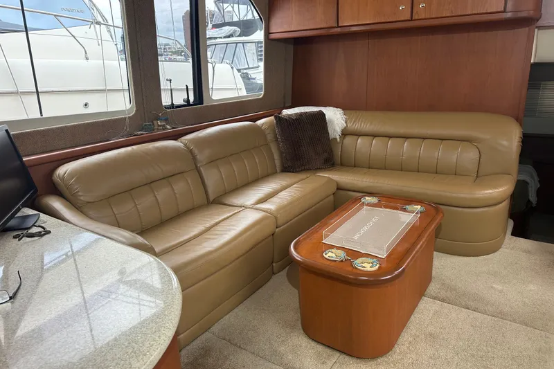 Slide: The Image of Luxurious interior of 2005 Silverton 43 Motor Yacht with leather seating and wooden accents. - 18