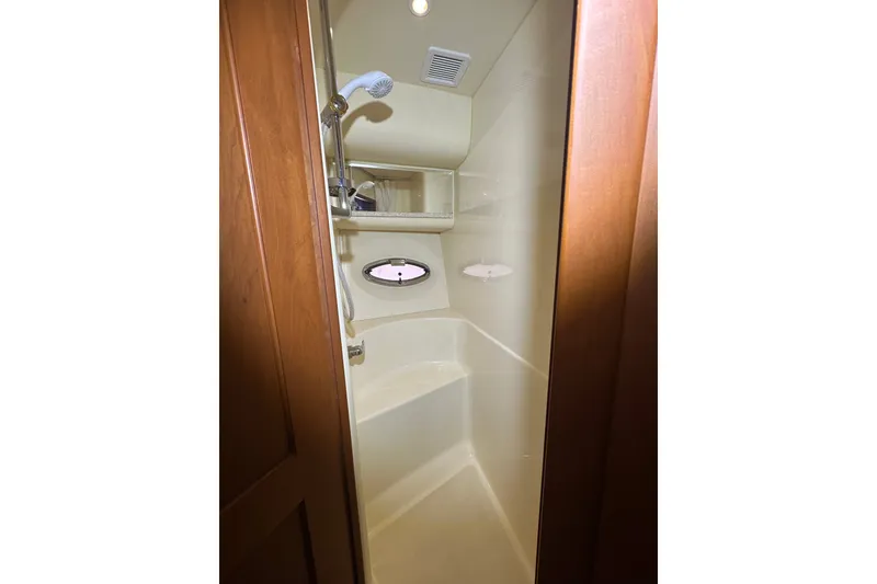 Slide: The Image of Shower area in 2005 Silverton 43 Motor Yacht with wooden door and porthole window. - 37