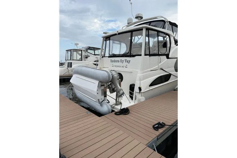 Slide: The Image of 2005 Silverton 43 Motor Yacht docked with inflatable boat attached. - 15