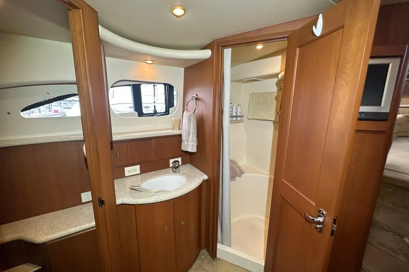 Slide: The Image of 2005 Silverton 43 Motor Yacht bathroom with wooden cabinetry and modern fixtures. - 27