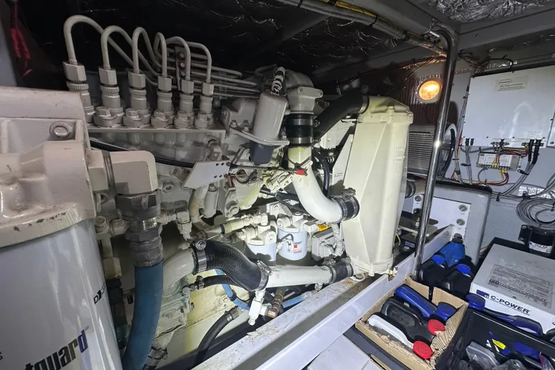 Slide: The Image of Engine room of a 2005 Silverton 43 Motor Yacht, showcasing mechanical components and wiring. - 43