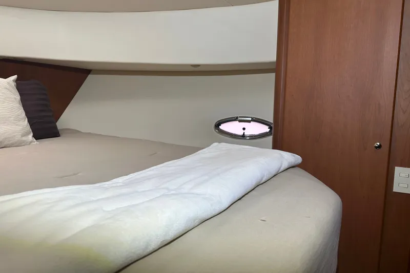 Slide: The Image of Interior cabin of 2005 Silverton 43 Motor Yacht with bed and porthole window. - 32