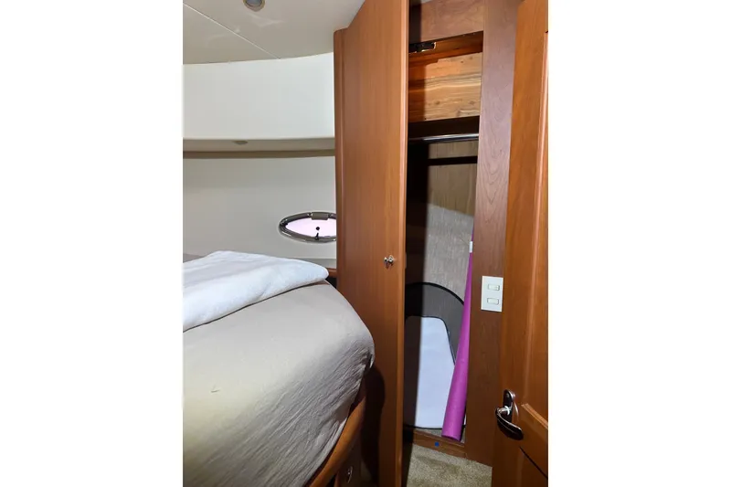 Slide: The Image of Interior of 2005 Silverton 43 Motor Yacht showing bedroom and closet space. - 33