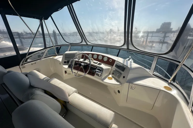 Slide: The Image of 2005 Silverton 43 Motor Yacht helm with panoramic marina view. - 19