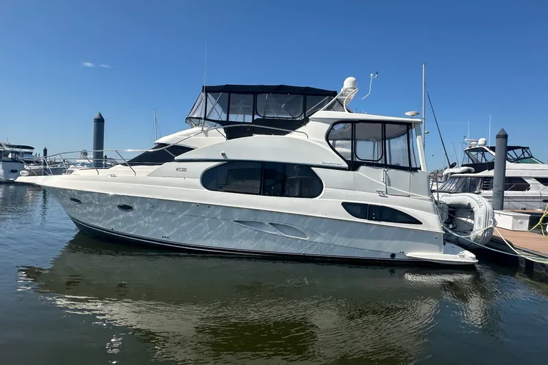 The Image of 2005 Silverton 43 Motor Yacht docked in a marina under clear blue skies. - 7