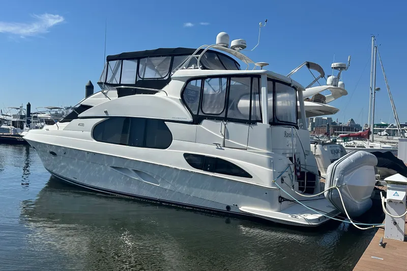 Slide: The Image of 2005 Silverton 43 Motor Yacht docked at marina under clear blue sky. - 11