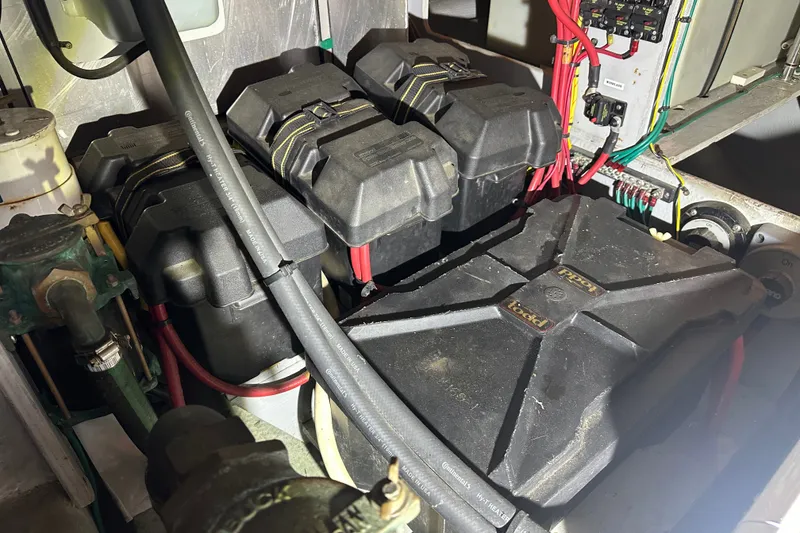 Slide: The Image of Engine room of a 2005 Silverton 43 Motor Yacht showing battery setup and wiring. - 45