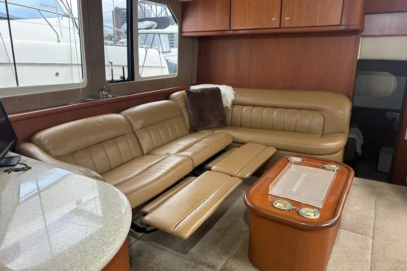 Slide: The Image of Luxurious interior of 2005 Silverton 43 Motor Yacht with leather seating and wooden accents. - 19