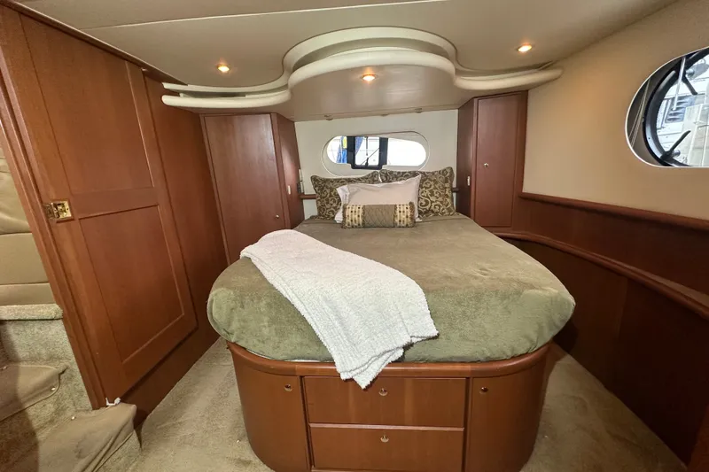 Slide: The Image of Luxurious bedroom interior of 2005 Silverton 43 Motor Yacht with elegant wood finishes. - 25