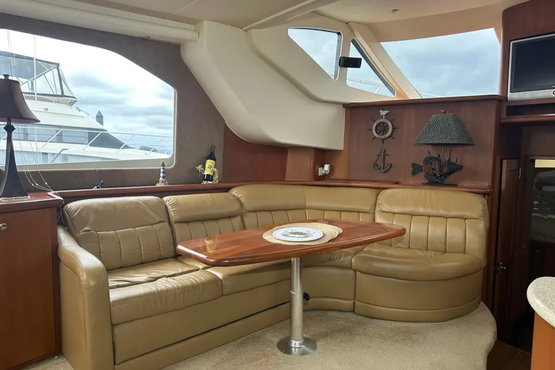 Slide: The Image of Luxurious interior of a 2005 Silverton 43 Motor Yacht with leather seating and nautical decor. - 17