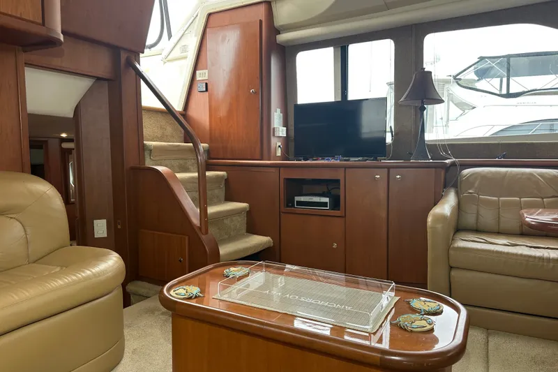 Slide: The Image of Interior of 2005 Silverton 43 Motor Yacht with cozy seating and entertainment area. - 16