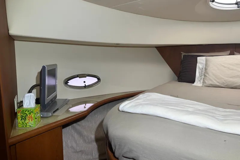 Slide: The Image of Interior of 2005 Silverton 43 Motor Yacht bedroom with bed, TV, and porthole. - 31