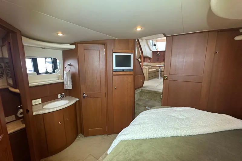 Slide: The Image of Interior of 2005 Silverton 43 Motor Yacht with wood cabinetry and cozy furnishings. - 29