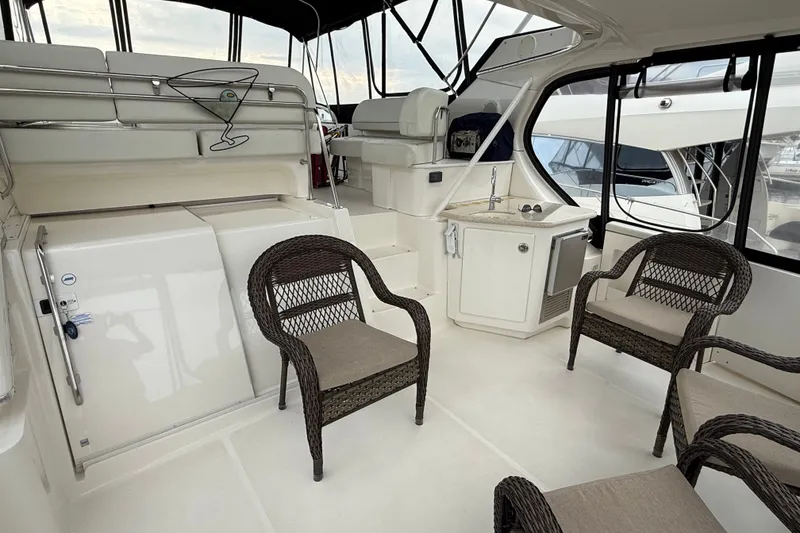 Slide: The Image of Spacious interior of 2005 Silverton 43 Motor Yacht with wicker chairs and kitchenette. - 27