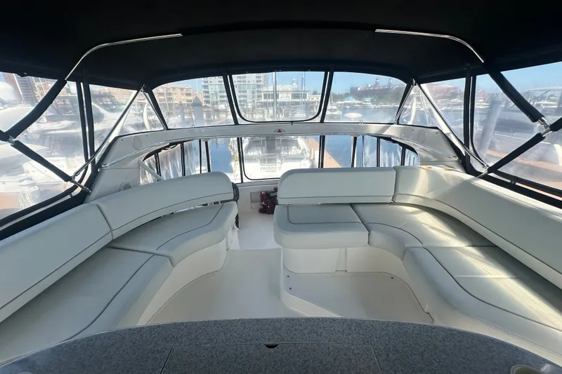 Slide: The Image of Interior view of 2005 Silverton 43 Motor Yacht with spacious seating and panoramic windows. - 21