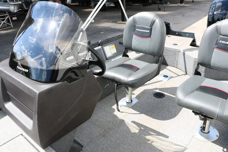Slide: The Image of The image shows the cockpit of a 2023 Tracker Pro Guide V16 with two cushioned seats. - 16