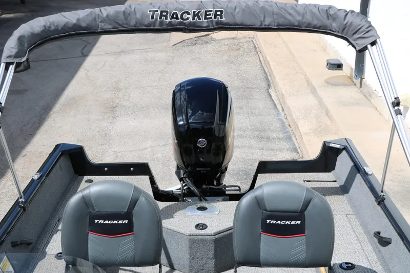 Slide: The Image of The image shows the cockpit of a Tracker Pro Guide V16 boat with two gray seats and an outboard motor. - 15
