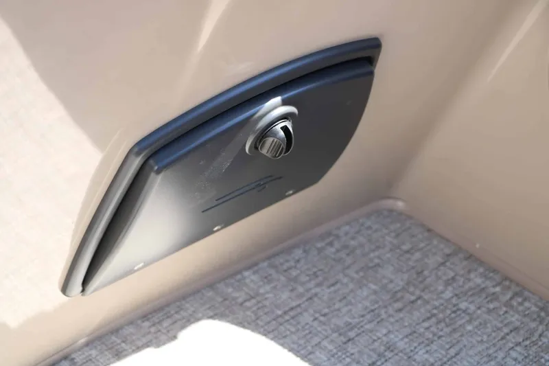 Slide: The Image of Close-up of a storage compartment with a twist lock on a Bennington 22 SF Tri Toon boat. - 40