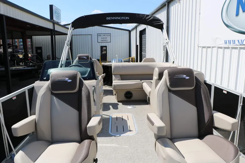 Slide: The Image of The image shows the interior of a 2027 Bennington 22 SF Tri Toon. It features comfortable seating and a canopy. - 28