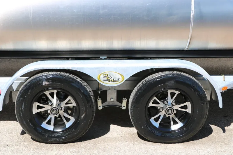 Slide: The Image of Close-up of a boat trailer with two black tires and silver rims. - 25
