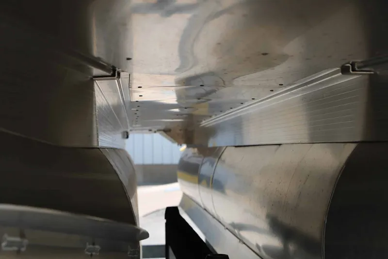 Slide: The Image of Close-up of the underside of a 2027 Bennington 22 SF Tri Toon, featuring aluminum hulls. - 11