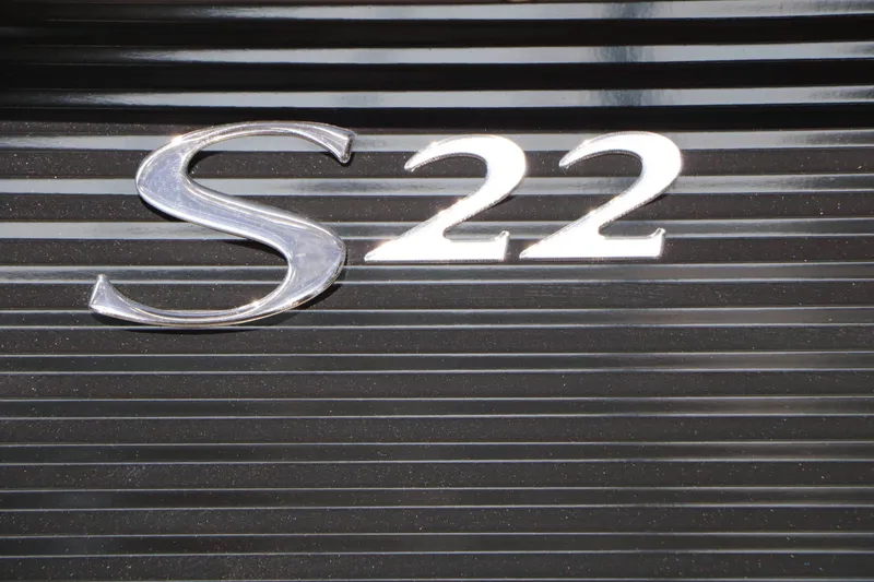 Slide: The Image of Close-up of the shiny "S22" emblem on a ribbed, dark background. - 24