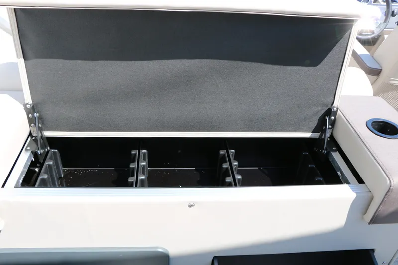 Slide: The Image of An open storage compartment on a 2027 Bennington 22 SF Tri Toon boat. - 49