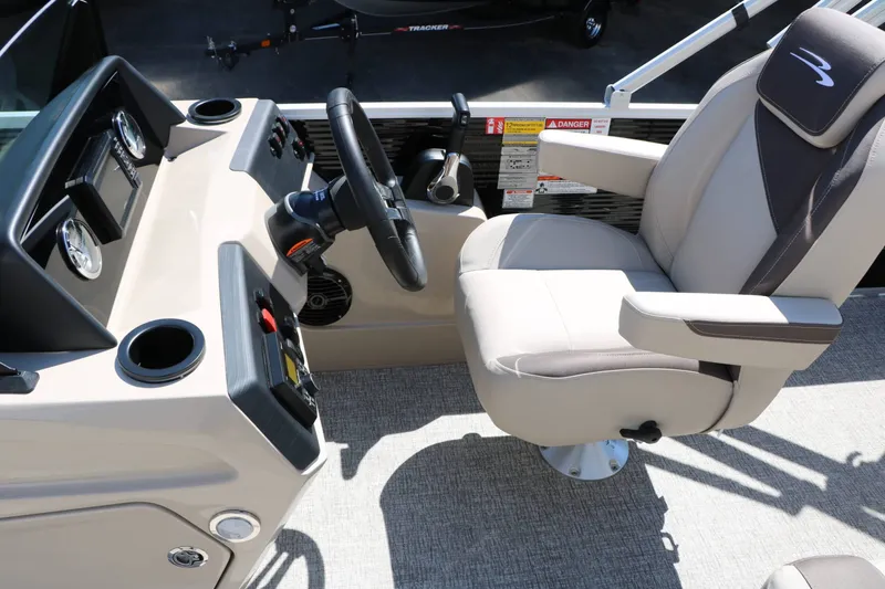 Slide: The Image of The image shows the cockpit of a 2027 Bennington 22 SF Tri Toon with a comfortable captain's chair. - 36