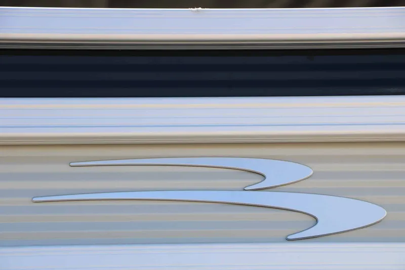 Slide: The Image of Close-up of a boat logo on a 2027 Bennington 22 SF Tri Toon. - 10