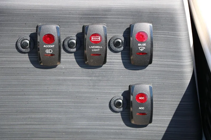 Slide: The Image of Close-up of four toggle switches on a boat panel labeled "Accent," "Livewell Light," "Bilge," and "ACC." - 42