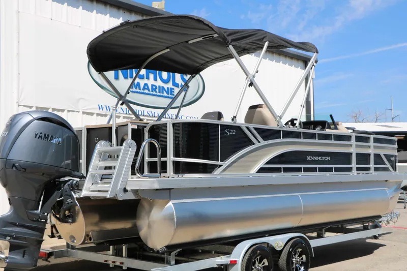 Slide: The Image of A 2027 Bennington 22 SF Tri Toon with a Yamaha outboard motor, on a trailer. - 15