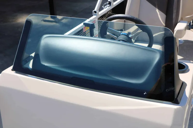 Slide: The Image of The image shows the dashboard of a Bennington 22 SF Tri Toon boat with a modern steering wheel. - 34