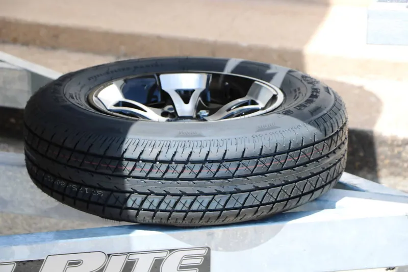 Slide: The Image of A single tire rests on a metal frame, featuring a shiny rim design. - 31