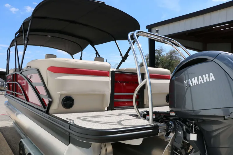 Slide: The Image of A 2027 Bennington 22 MFB Tri Toon with a Yamaha engine. It features red accents and a sunshade. - 18