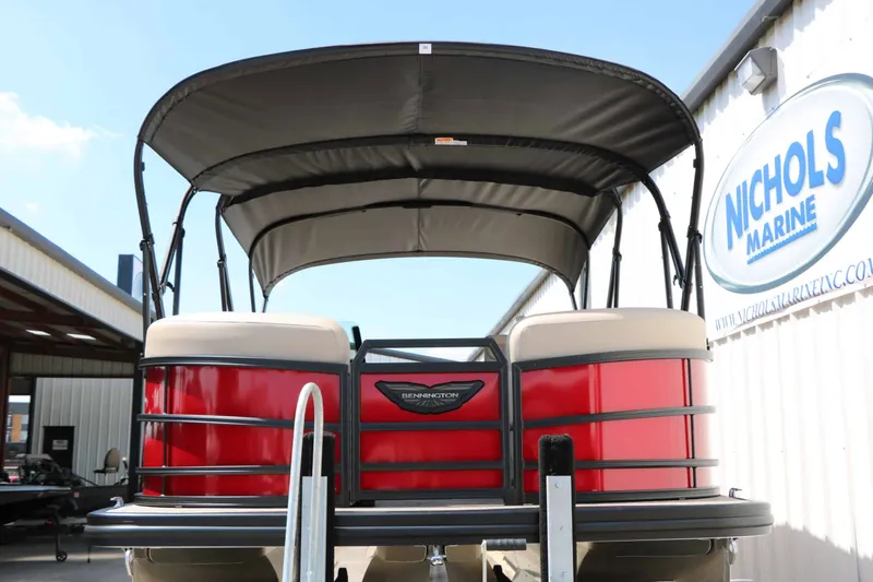 Slide: The Image of A red Bennington 22 MFB Tri Toon boat with a canopy is in a dock area. - 9