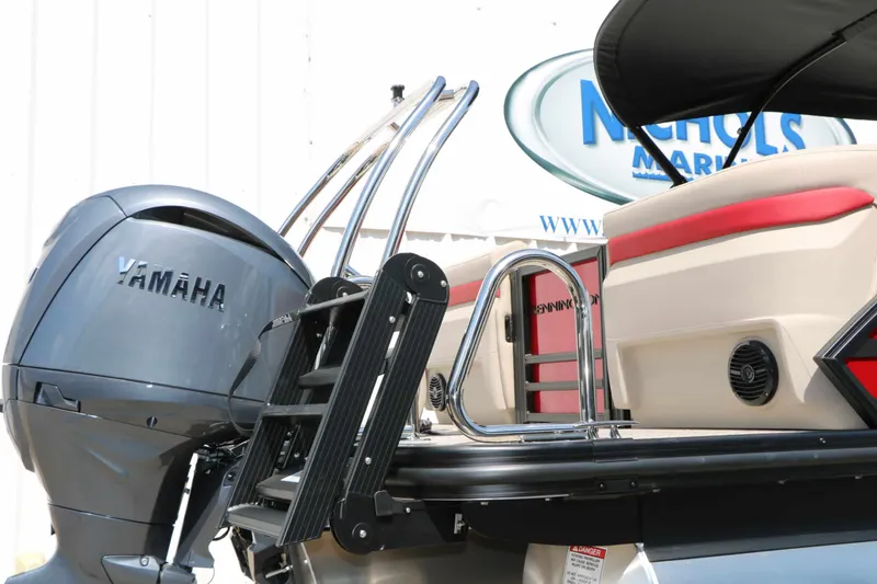Slide: The Image of A 2027 Bennington 22 MFB Tri Toon with a Yamaha outboard motor and a swim ladder. - 21