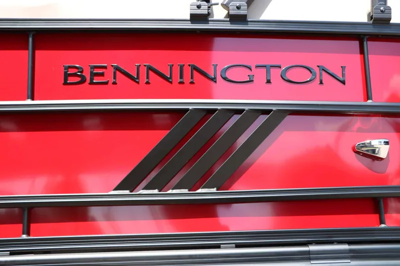Slide: The Image of Close-up of the Bennington logo on a red boat hull with black accents. - 27