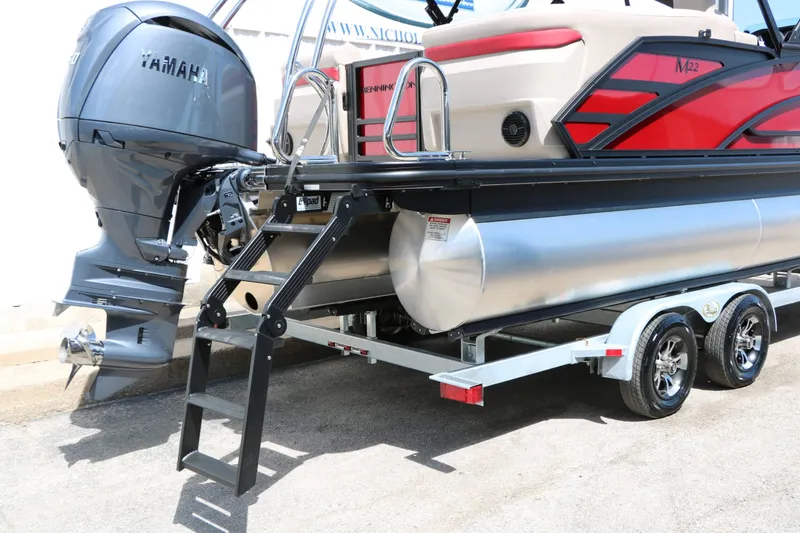 Slide: The Image of A 2027 Bennington 22 MFB Tri Toon on a trailer. Visible is a Yamaha outboard motor. - 23