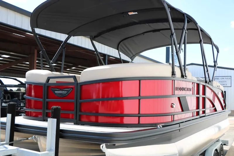 Slide: The Image of A red 2027 Bennington 22 MFB Tri Toon with a black canopy, on a trailer. - 10