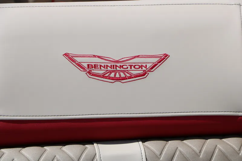 Slide: The Image of Close-up of the Bennington logo on a white and red seat cushion. - 36