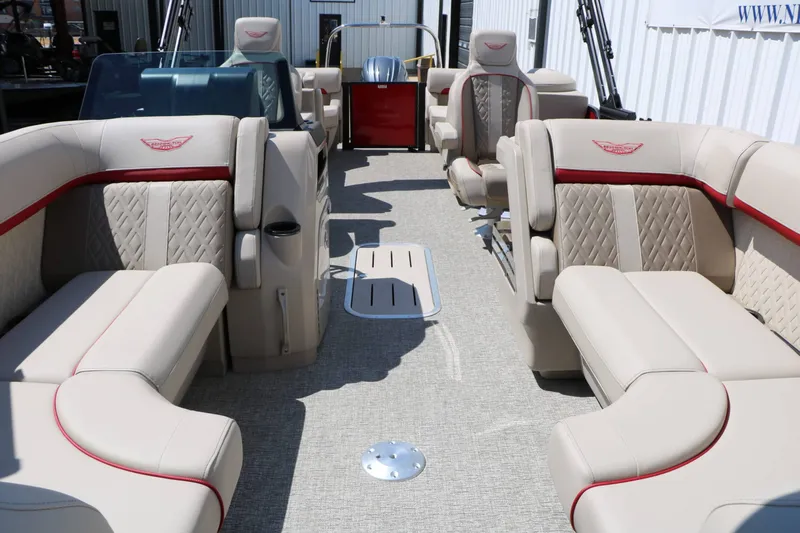 Slide: The Image of The image shows the interior of a 2027 Bennington 22 MFB Tri Toon with luxurious cream seating. - 32