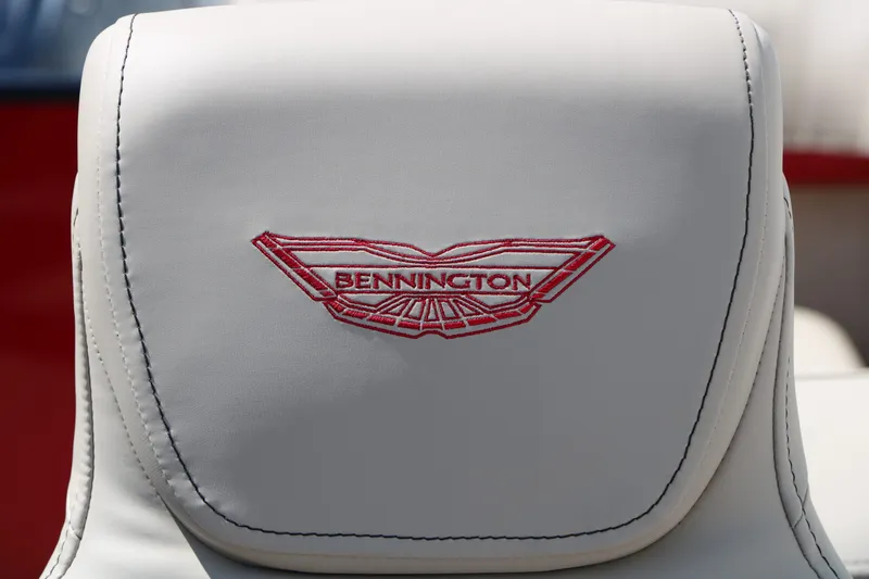 Slide: The Image of Close-up of a white seat with the red Bennington logo. - 46