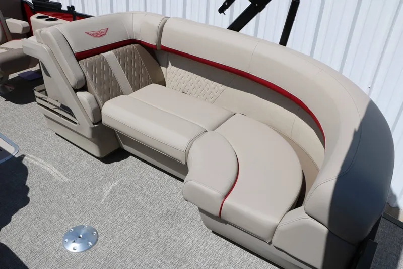 Slide: The Image of The image shows a luxurious beige leather seating area with red accents on a boat. - 33