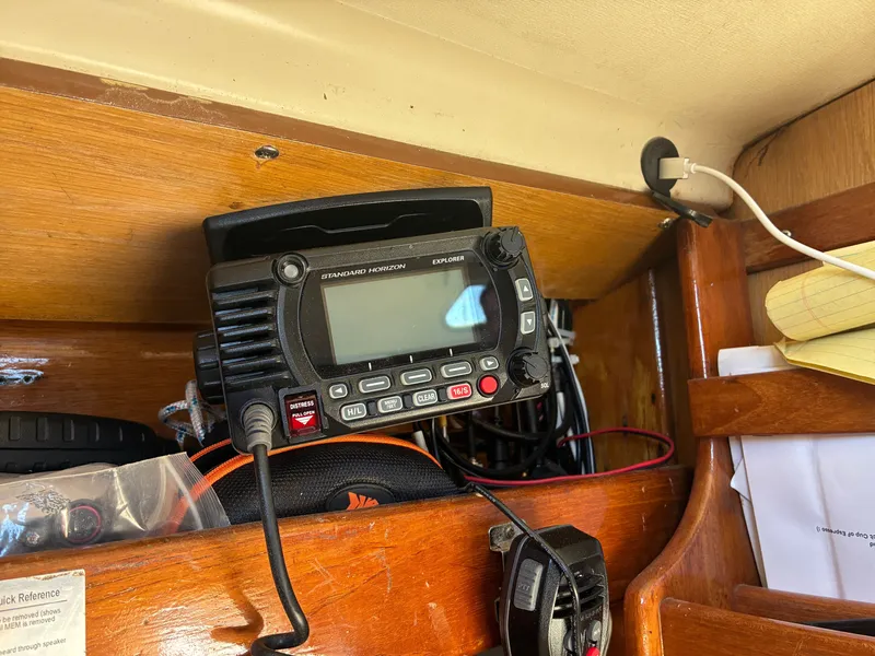 Slide: The Image of A radio is mounted on a wooden shelf, surrounded by cables and notepads. - 38