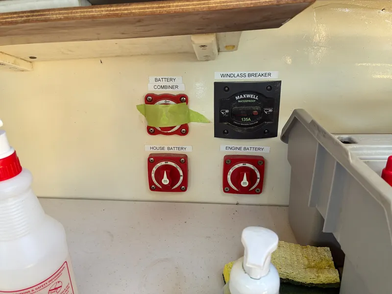 Slide: The Image of A boat control panel with battery switches and a windlass breaker, surrounded by cleaning supplies. - 40