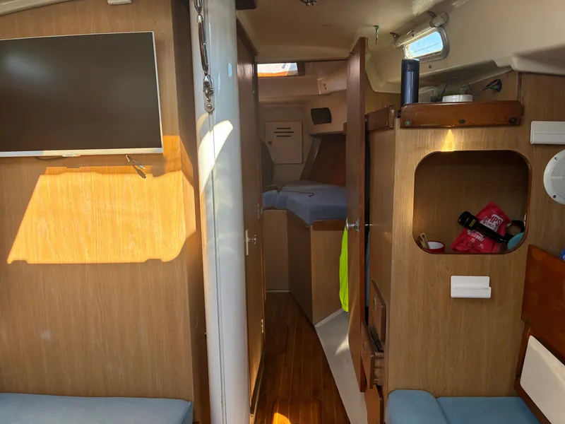 Slide: The Image of Interior of a 1973 Pearson 36 with wood paneling and a small TV. - 28
