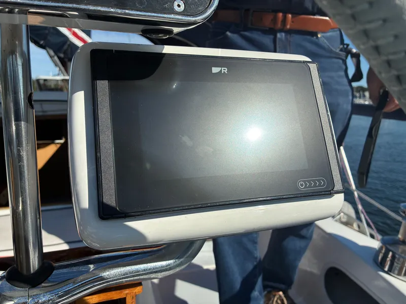 Slide: The Image of A navigation device is mounted on a boat, with a man in the background. - 22