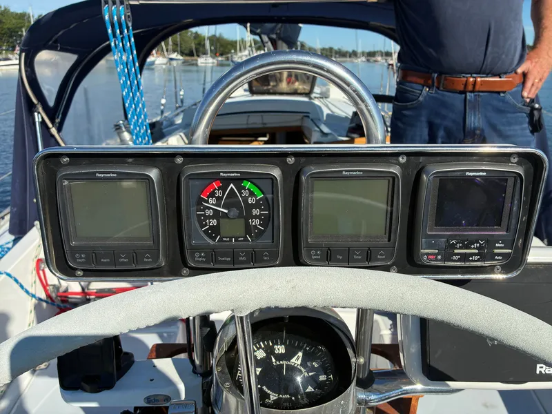 Slide: The Image of The cockpit of a 1973 Pearson 36 with navigation instruments and a compass. - 21